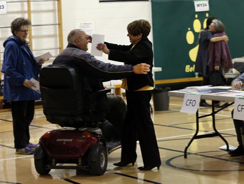 Election Day Winnipeg Mayoral Candidate Judy Wasylycia-Leis casts her vote just after 9am at Luxton School polling station  In pic greeted by Victor and his wife Gail Witroway .  About a dozen people lined up before 8am at Luxton School polling station to vote . Oct. 22 2014 / KEN GIGLIOTTI / WINNIPEG FREE PRESS