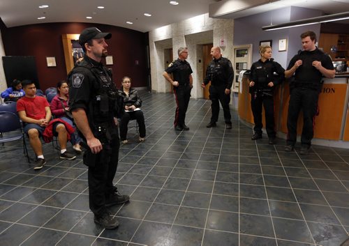 WPS have police guards in the public entrance and waiting area of PSB. Wpg Police spokesperson Constable Eric Hofley would not confirm the reason why they are  there .  Oct. 22 2014 / KEN GIGLIOTTI / WINNIPEG FREE PRESS