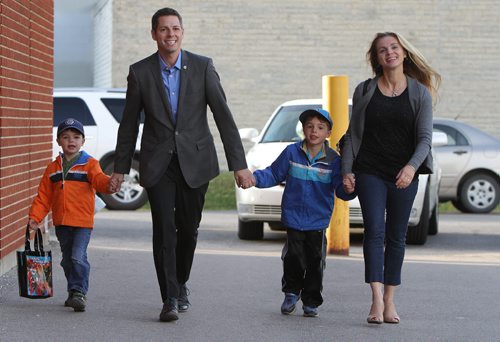 Winnipeg mayoral candidate Brian Bowman arrives to vote at Charleswood School with his family Äì¬wife, Tracy, and sons Hayden, 6, (second right) and Austin, 4 Äì on Wed., Oct. 22, 2014. Photo by Jason Halstead/Winnipeg Free Press