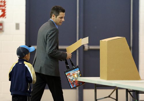 Winnipeg mayoral candidate Brian Bowman votes at Charleswood School with his son Hayden, 6, on Wed., Oct. 22, 2014. Photo by Jason Halstead/Winnipeg Free Press