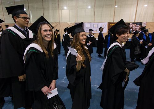 Bianca Macatangay (centre) fans herself as all the graduating students gather in the Max Bell Track Centre prior to the start of the fall 2014 University of Manitoba Convocation. 141022 - Wednesday, October 22, 2014 -  (MIKE DEAL / WINNIPEG FREE PRESS)