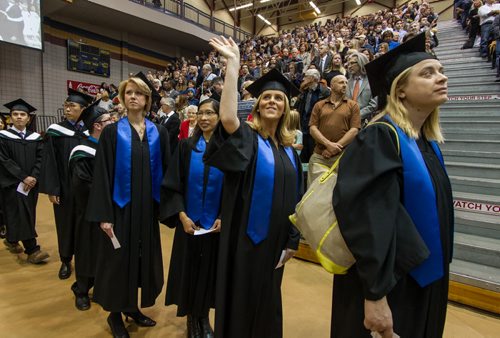 Kimberly Zealand waves as she enters the Investors Group gym with other graduating students for the fall 2014 University of Manitoba Convocation. 141022 - Wednesday, October 22, 2014 -  (MIKE DEAL / WINNIPEG FREE PRESS)