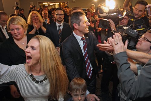 Brian Bowman the mayor elect of Winnipeg arrives  with his wife Tracy, left, through a sea of supporters and cameras at his campaign headquarters at the Inn at the Forks in Winnipeg Wednesday night-See Aldo Santin story - Oct 22, 2014   (JOE BRYKSA / WINNIPEG FREE PRESS)