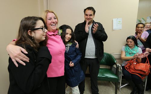 Daniel McIntyre candidate Cindy Gilroy celebrates victory with her daughters Hayley, 13, and Kayla, 10, and partner Wade Parke at her campaign office on Sargent Avenue on Wed., Oct. 22, 2014. Photo by Jason Halstead/Winnipeg Free Press