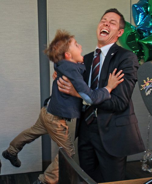 Brian Bowman the mayor elect of Winnipeg gets a hug from his son Hayden at his campaign headquarters at the Inn at the Forks in Winnipeg Wednesday night-See Aldo Santin story - Oct 22, 2014   (JOE BRYKSA / WINNIPEG FREE PRESS)