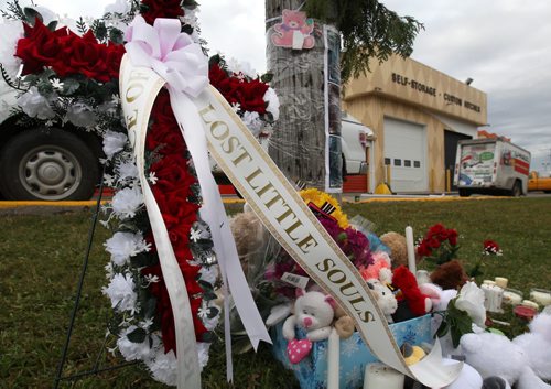 A memorial was left last night by individuals who held a vigil at the U-Haul on McPhillips and Elgin where Wpg Police discovered the remains of six infants in a storage locker-Standup Photo - Oct 23, 2014   (JOE BRYKSA / WINNIPEG FREE PRESS)