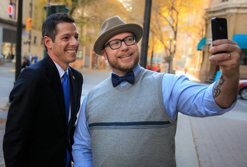 Luke Nolan snaps a selfie with mayor-elect Brian Bowman the morning after his election win. In one short walk in the Exchange District on Thursday a dozen people stopped to congratulate Bowman. 141023 - Thursday, October 23, 2014 - (Melissa Tait / Winnipeg Free Press)