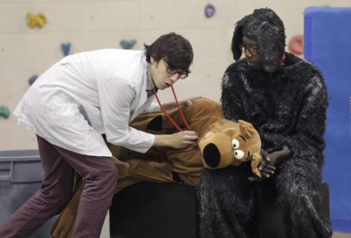 The Winnipeg Humane Society in partnership with the Pembina Trails School Division created the Trampers Story, it was performed for children at the Ryerson Elementary School Thursday. The 30-minute one-act play teaches the Humane Educational animal welfare curriculum to grades one to four in a creative and interactive way. Actor Dale Goodbrandson plays a veterinarian in a scene checking  Galvin Niu as Kriss Kross with Buhle Mwanza as Tramper at right.  Doug Speirs  story Wayne Glowacki/Winnipeg Free Press Oct.23  2014