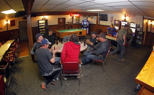 49.8 feature on rural hotel beverage rooms. Notre Dame Hotel owner Angelo Mondragon, not in photo, organizes the Rural Hotel Association that will try to save these dying hotel beverage rooms. This is a group of men who were drinking in the bar that evening. BORIS MINKEVICH / WINNIPEG FREE PRESS October 23, 2014