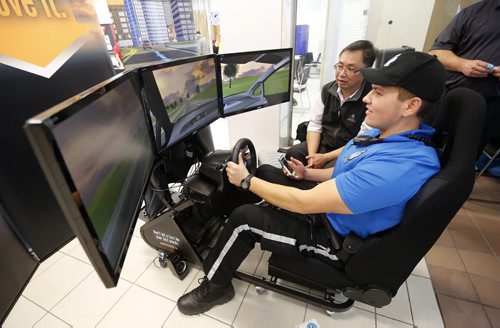 LOCAL STDUP - Safety Expo .in pic left rear  MPI's Raymond Au uses a driving simulator to show the dangers of distractions like texting while driving with Police Cadets .(not for publication cadets don't give their names)  .The Winnipeg Police Service would like to invite members of the media to the 2014 Creating a Culture of Safety , Safety Expo taking place at Portage Place Mall today starting at 10:00 a.m.  7:00 p.m. With displays by Wpg Police K-9 and Bomb Unit ,  ,Fire Paramedic services , lectures , resource material ,Oct. 24 2014 / KEN GIGLIOTTI / WINNIPEG FREE PRESS