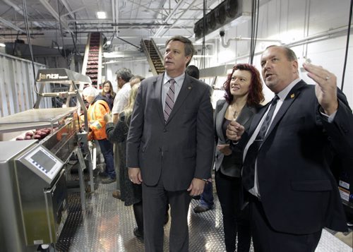 From right, Larry McIntosh, pres. and CEO of Peak of the Market, Sharon Blady, Minister of Healthy Living and Seniors, and Lawrence Toet,MP, tour Peak of the Market's brand new $4-million processing system.  The investment was made possible by a contribution of over $336,000 from Growing Forward 2 Innovation Funding. Thanks to the Governments of Canada and Manitoba, this-state-of-the-art potato and onion packaging equipment has several innovative firsts. The automated and robotic packaging equipment, including 12 foot high robots results in superior handling of the vegetables to ensure the highest quality product. see release.  Wayne Glowacki/Winnipeg Free Press Oct.24  2014