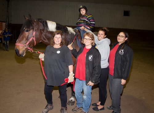 The Fraternal Order of Eagles (FOE), Aerie 3360, recently donated a $12,000 lift (used to seat people on horseback) to the Manitoba Riding for the Disabled Association (MRDA). The lift has been installed at West Wind Stables. The donation was made in memory of Bobby Smith, whose family was in attendance. The MRDA is seeking donations for more harnesses and to expand their program. To learn more, visit mrda.cc. Pictured, from left, are Kimberly Barry (volunteer), Diane Borger (instructor), Kelli MacKay (walker) and Amy Collins (therapist), with Aliyah Salkeild on Princess. (John Johnston / Winnipeg Free Press)