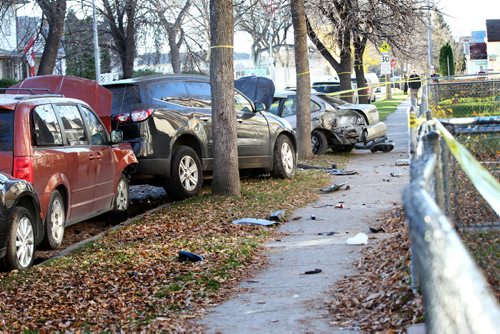 Police investigate a  multi-vehicle accident scene involving at least 5 vehicles with a Nissan Altima left upside down in the front of 547 Banning street between Ellice and St. Mathews Saturday.     Oct 25,  2014 Ruth Bonneville / Winnipeg Free Press