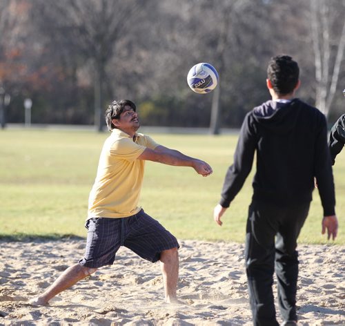 Reza  Tareghian plays beach volleyball with his friends in shorts and barefoot  in unseasonably warm weather Saturday  St. Vital Park.   Oct 25,  2014 Ruth Bonneville / Winnipeg Free Press