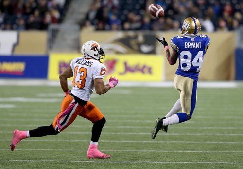 Winnipeg Blue Bombers' Romby Bryant (84) catches a pass in front of BC Lions' Tom Williams (13) during first half CFL football in Winnipeg, Saturday, October 25, 2014. (TREVOR HAGAN/WINNIPEG FREE PRESS)