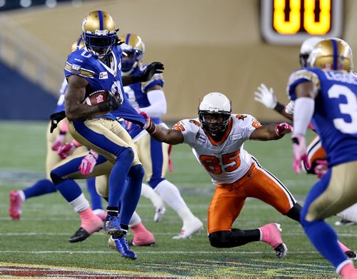 Winnipeg Blue Bombers' Johnny Sears (0) breaks a tackle by BC Lions' Shawn Gore (85) after he intercepted a pass during second half CFL football in Winnipeg, Saturday, October 25, 2014. (TREVOR HAGAN/WINNIPEG FREE PRESS)