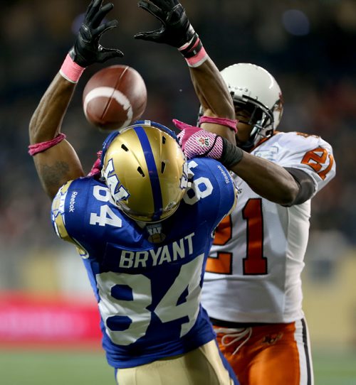 Winnipeg Blue Bombers' Romby Bryant (84) can't haul in a 2 point conversion behind BC Lions' Ryan Phillips (21) during second half CFL football in Winnipeg, Saturday, October 25, 2014. (TREVOR HAGAN/WINNIPEG FREE PRESS)
