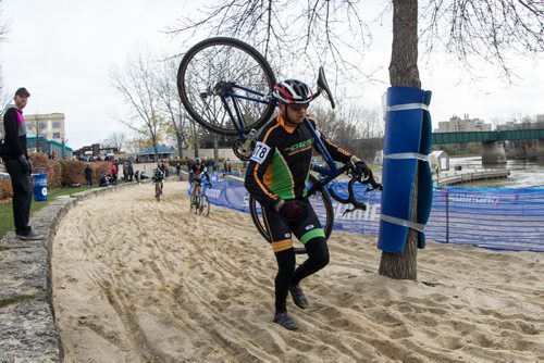 Sam Nayet from St. Pierre-Jolys, MB and team Offroad Syndicate runs through the grueling sand pit portion of the cycle-cross event being held at The Forks Sunday. 141026 - Sunday, October 26, 2014 -  (MIKE DEAL / WINNIPEG FREE PRESS)