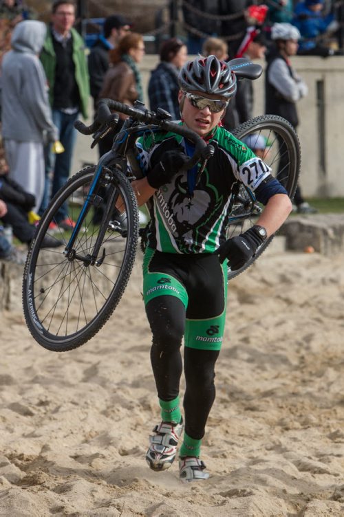 Matthew Boyle from East St. Paul, MB and team Bikes and Beyond carries his bike through the grueling sand pit portion of the cycle-cross event being held at The Forks Sunday. 141026 - Sunday, October 26, 2014 -  (MIKE DEAL / WINNIPEG FREE PRESS)