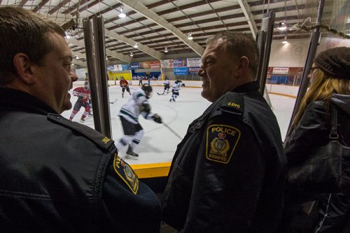 Winnipeg Police Officers Brad Sparrow (left) and Sean Donovan (right) watch a minor league hockey game between the AAA midget Winnipeg Hawks and the Winnipeg Warriors at Notre Dame Arena Sunday morning as part of the CHECK-ing In program between the WPS and Hockey Winnipeg. 141026 - Sunday, October 26, 2014 -  (MIKE DEAL / WINNIPEG FREE PRESS)