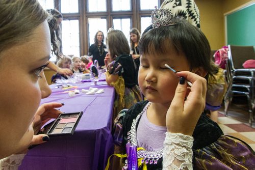 Alexus Lee, 3, gets her makeup applied by volunteer, Mary Chipman, during the Princess for a Day fundraising event at the castle at the Canadian Mennonite University. Around sixty little girls including five who are battling life-threatening illnesses are taking part in a unique fundraising event for the Childrens Wish Foundation  Manitoba and Nunavut.  141026 - Sunday, October 26, 2014 -  (MIKE DEAL / WINNIPEG FREE PRESS)
