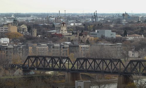 The Old St. Boniface City Hall clock tower can be seen in the distance past the Waterfront Drive train bridge.  141027 - Monday, October 27, 2014 -  (MIKE DEAL / WINNIPEG FREE PRESS)