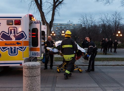 Paramedics wheel one male up the ramps behind the Legislative Building after he was rescued from the Assiniboine River around 6pm Monday evening. 141027 - Monday, October 27, 2014 - (Melissa Tait / Winnipeg Free Press)