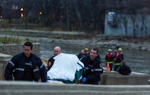 Paramedics wheel one male up the ramps behind the Legislative Building after he was rescued from the Assiniboine River around 6pm Monday evening. 141027 - Monday, October 27, 2014 - (Melissa Tait / Winnipeg Free Press)