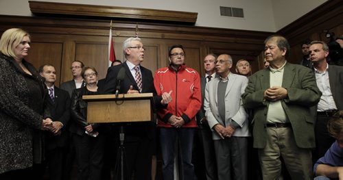 Premier Greg Selinger with his MLAs at the news conference Tuesday afternoon in the Manitoba Legislative building. Greg Selinger will carry on as Premier of Manitoba.  Larry Kusch/ Bruce Owen stories. Wayne Glowacki/Winnipeg Free Press Oct.28   2014Bruce Owen story. Wayne Glowacki/Winnipeg Free Press Oct.28   2014