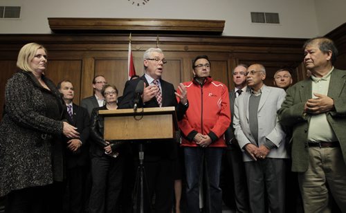 Premier Greg Selinger with his MLAs at the news conference Tuesday afternoon in the Manitoba Legislative building. Greg Selinger will carry on as Premier of Manitoba.  Larry Kusch/ Bruce Owen stories. Wayne Glowacki/Winnipeg Free Press Oct.28   2014Bruce Owen story. Wayne Glowacki/Winnipeg Free Press Oct.28   2014