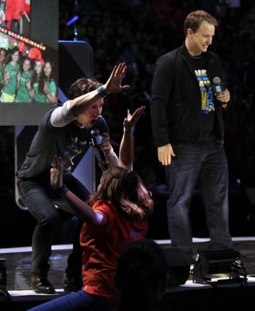 Craig at left  gives the high five to volunteer with Marc Kielburger near the end of the WE Day event in the MTS Centre Wednesday. Nick Martin¤ story. Wayne Glowacki/Winnipeg Free Press Oct.29 ¤ 2014