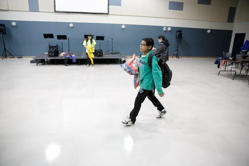 Kassidy Bone carries his pillow out to the bus after at Elim Chapel. Waywayseecappo at We Day Manitoba 2014.  141029 - Wednesday, October 29, 2014 - (Melissa Tait / Winnipeg Free Press)