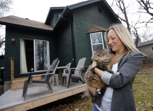 BIZ . Cats and Renters . JEN KENNEDY  with cat Dewey one of her  three cats for a story on whether landlords should be allowed to charge tenants an additional monthly rental fee (pet rent) if they have a pet. Pet rents are becoming the norm in the United States, and a local landlord group and the Winnipeg Humane Society want the provincial government to allow it here, as well. Landlords are already allowed to charge a pet damage deposit, and this would be over and above that .  Business / Murray McNeill Oct. 30 2014 / KEN GIGLIOTTI / WINNIPEG FREE PRESS