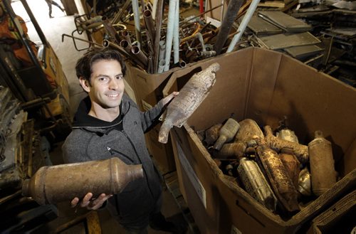 Adam Chisick, vice pres. of Urbanmine Metal Recycling, a metal recycling company that buys and recycles catalytic converters.  He is holding two from their box of catalytic converters.  Aidan Geary story  Wayne Glowacki/Winnipeg Free Press Oct.30   2014