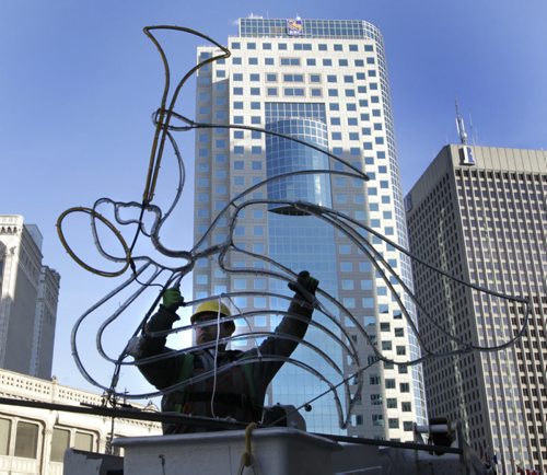 Dustin Kipling prepares to rise up with the angel Christmas street light decoration to be installed on a light post on Portage Ave. on a crisp -3C Friday morning.   Wayne Glowacki/Winnipeg Free Press Oct.31   2014