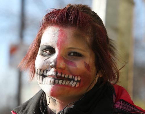 A made-up Alex Favel, 17, waits for a bus on Selkirk Avenue on Fri., Oct. 31, 2014. She was on her way to Tyndall Park to take her young cousins out trick-or-treating. Photo by Jason Halstead/Winnipeg Free Press For stand alone