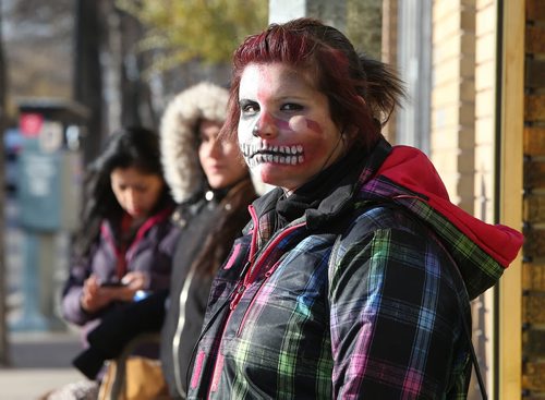 A made-up Alex Favel, 17, waits for a bus on Selkirk Avenue on Fri., Oct. 31, 2014. She was on her way to Tyndall Park to take her young cousins out trick-or-treating. Photo by Jason Halstead/Winnipeg Free Press For stand alone