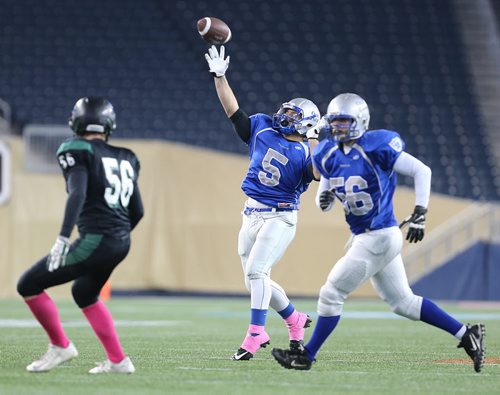 Oak Park Raiders RB Brady Oliveira throws a TD on a trip play against the Vincent Massey Trojans during John Potter Division AAA high school football action at Investors Group Field on Fri., Oct. 31, 2014. Photo by Jason Halstead/Winnipeg Free Press