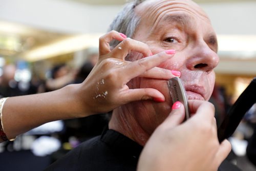 Beau Fritzsche a radio announcer with Bob FM, gets a strait razor shave from Tommy Gun's Barbershop at Kildonan Place Centre Court Saturday afternoon along with other Winnipeg celebrities to kick-off Movember,  an annual month-long drive in November for mens health issues.  Standup photo  Nov 1,  2014 Ruth Bonneville / Winnipeg Free Press