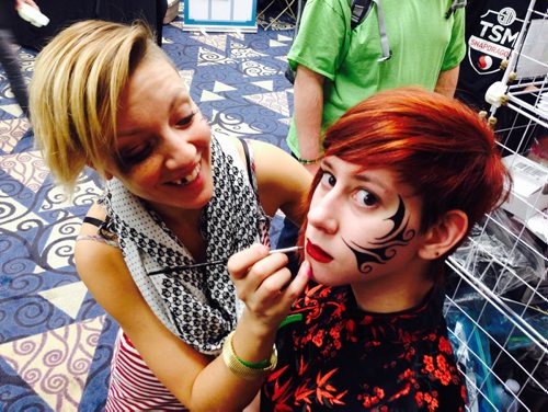 Kira Peveira, gets tribal makeup applied by artist Kristin Johnson with Cartizan face painting  at the Central Canada Comic Con event at the RBC Convention Centre Saturday. Standup photo for web  Nov 1/14 Ruth Bonneville / Winnipeg Free Press