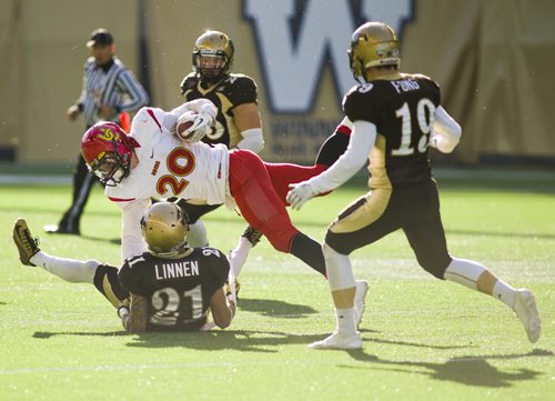 141101 Winnipeg - DAVID LIPNOWSKI / WINNIPEG FREE PRESS  The University of Manitoba Bisons take down Calgary Dinos Mercer Timiss (#20) at Investors Group Field Saturday November 1, 2014. The Bisons beat the Dinos 50-31 which secures them a playoff spot.