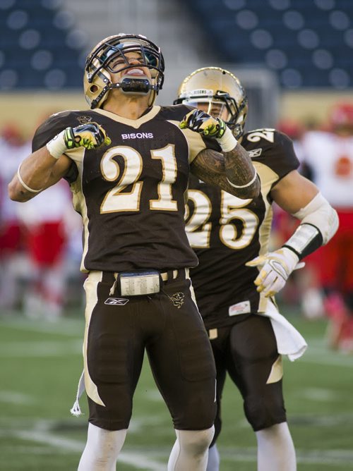 141101 Winnipeg - DAVID LIPNOWSKI / WINNIPEG FREE PRESS  The University of Manitoba Jordan Linnen (#21) celebrates a Calgary Dinos fumble during their game at Investors Group Field Saturday November 1, 2014. The Bisons beat the Dinos 50-31 which secures them a playoff spot.