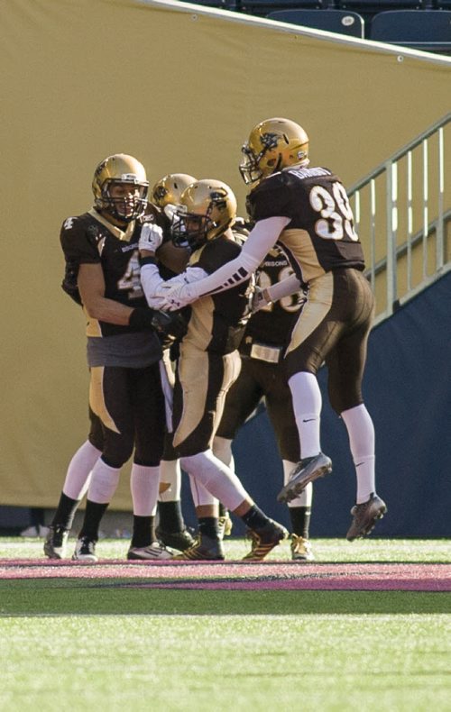 141101 Winnipeg - DAVID LIPNOWSKI / WINNIPEG FREE PRESS  The University of Manitoba Bisons celebrate a touch down against the Calgary Dinos at Investors Group Field Saturday November 1, 2014. The Bisons beat the Dinos 50-31 which secures them a playoff spot.