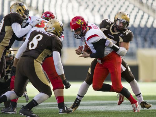 141101 Winnipeg - DAVID LIPNOWSKI / WINNIPEG FREE PRESS  The University of Manitoba Bisons take down Calgary Dinos Andrew Buckley (#8) at Investors Group Field Saturday November 1, 2014. The Bisons beat the Dinos 50-31 which secures them a playoff spot.