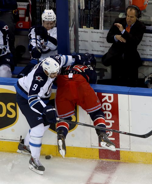 Winnipeg Jets' Evander Kane (9) hits New York Rangers' Chris Mueller (14) hard during second period NHL hockey at Madison Square Garden in New York City, Saturday, November 1, 2014. (TREVOR HAGAN/WINNIPEG FREE PRESS)