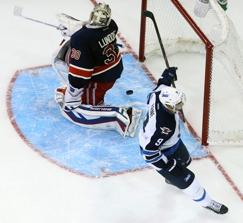 Winnipeg Jets' Evander Kane (9) beats New York Rangers' goaltender Henrik Lundqvist (30) to end the game during the shootout during NHL hockey at Madison Square Garden in New York City, Saturday, November 1, 2014. (TREVOR HAGAN/WINNIPEG FREE PRESS)