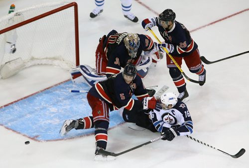 Winnipeg Jets' Andrew Ladd (16) just misses the open net as he's pushed to the ice by New York Rangers' Dan Girardi (5) during overtime NHL hockey at Madison Square Garden in New York City, Saturday, November 1, 2014. (TREVOR HAGAN/WINNIPEG FREE PRESS)