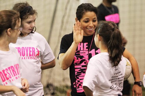 Canadian Olympic bronze medallist Desiree Scott gives out some high-fives after working out with girls aged 9-18 at the First Annual Desiree Scott KidSport Winnipeg Soccer Camp at the Seven Oaks Soccer Complex. 141102 November 02, 2014 Mike Deal / Winnipeg Free Press