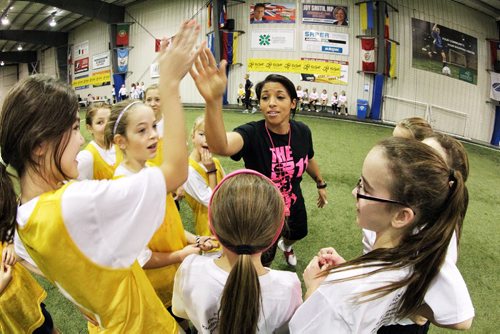 Canadian Olympic bronze medallist Desiree Scott high-gives during a pep-talk just before a scrimmage game with girls aged 9-18 at the First Annual Desiree Scott KidSport Winnipeg Soccer Camp at the Seven Oaks Soccer Complex. 141102 November 02, 2014 Mike Deal / Winnipeg Free Press