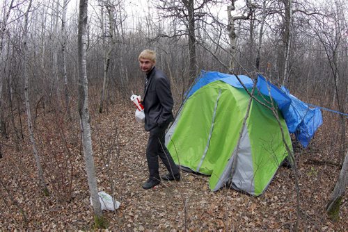 20 year old Austin Saunders lives in a tent in the forest where the Brenda Leipsic dog park is. Gord Sinclair yarn. BORIS MINKEVICH / WINNIPEG FREE PRESS November 3, 2014